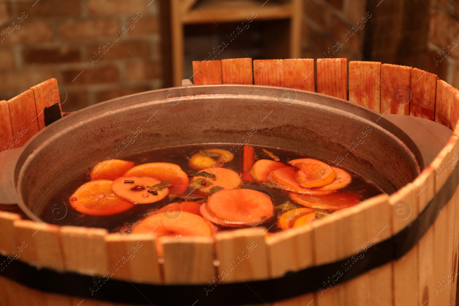 Photo of Large cauldron with tasty mulled wine at winter fair