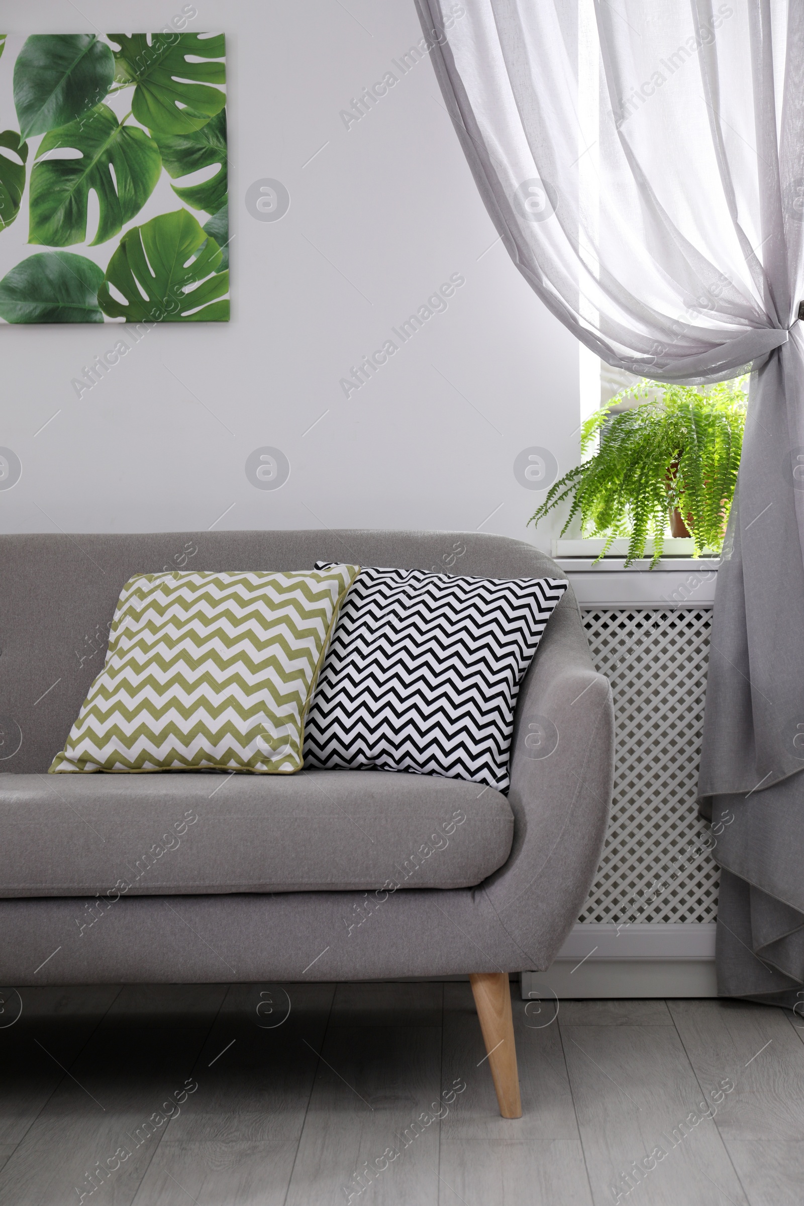 Photo of Modern comfortable sofa in stylish home interior