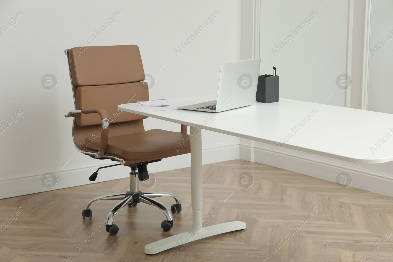 Photo of Director's office with large wooden table and comfortable armchair. Interior design