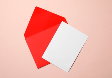 Photo of Letter envelope and card on beige background, top view. Space for text