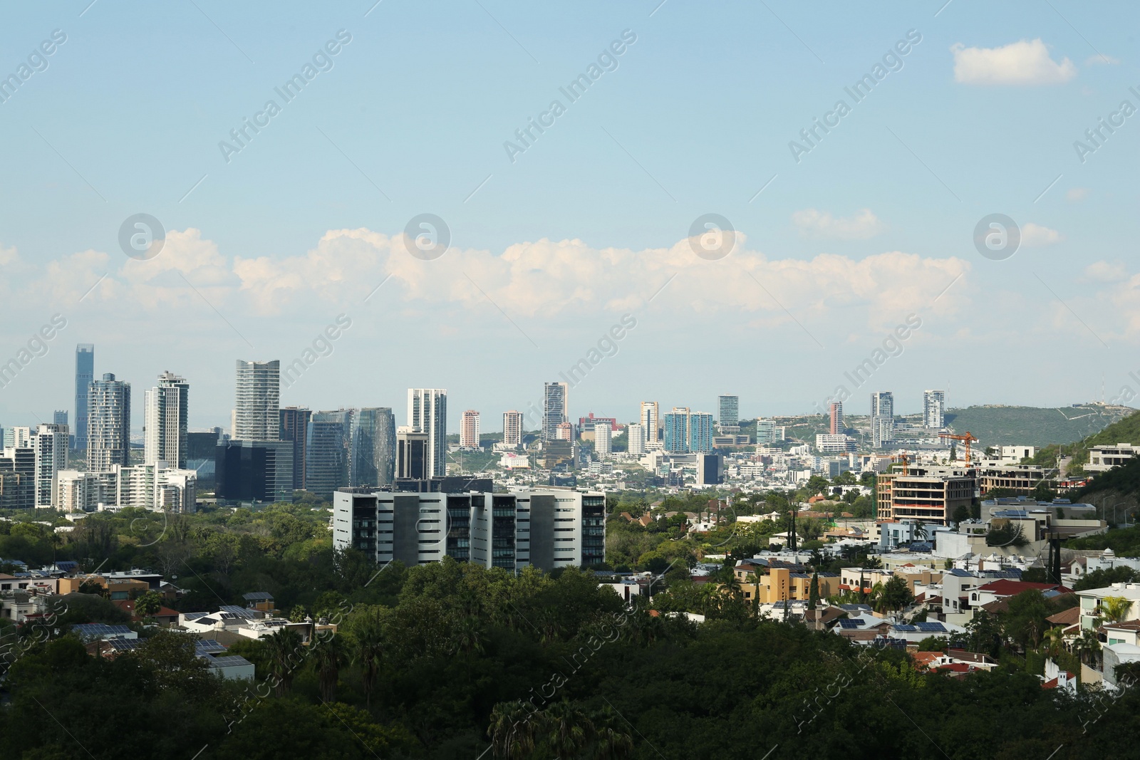 Photo of Picturesque view of city and green trees