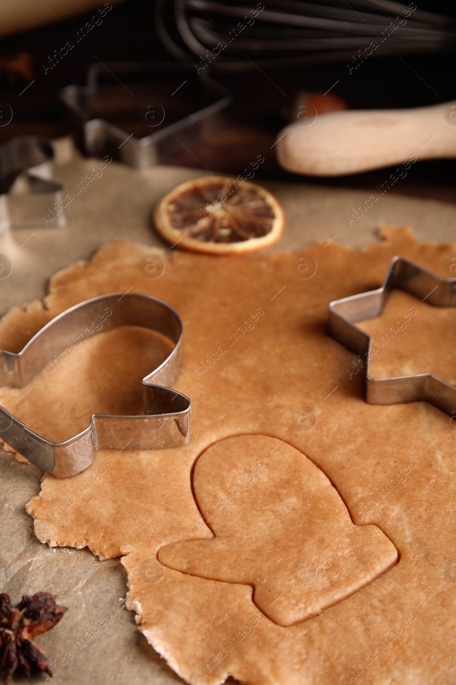 Photo of Making homemade Christmas cookies. Dough and cutters on table, closeup