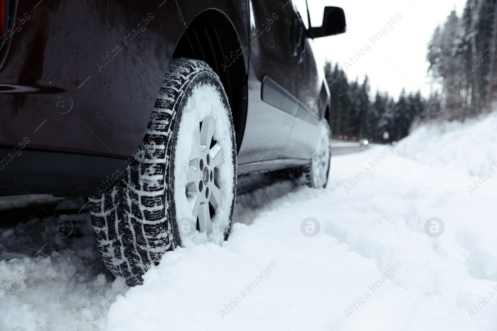 Photo of Closeup view of car in snow near road. Space for text