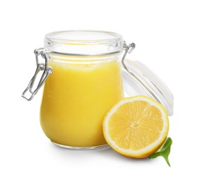 Delicious lemon curd in glass jar, fresh citrus fruit and green leaf isolated on white