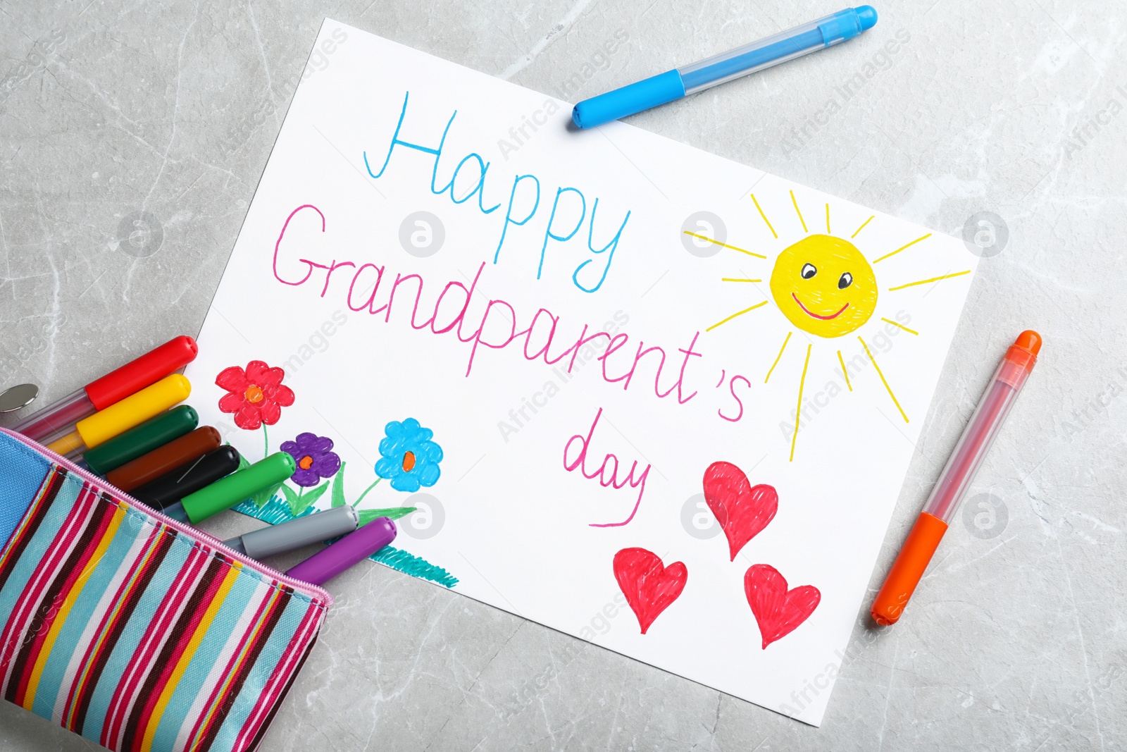 Photo of Beautiful drawing on grey table, flat lay. Happy Grandparents Day