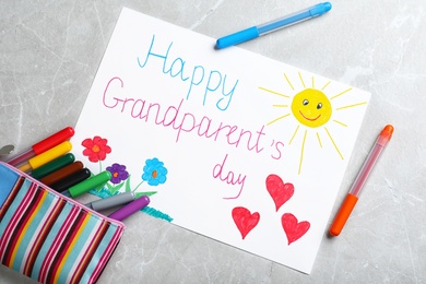 Photo of Beautiful drawing on grey table, flat lay. Happy Grandparents Day