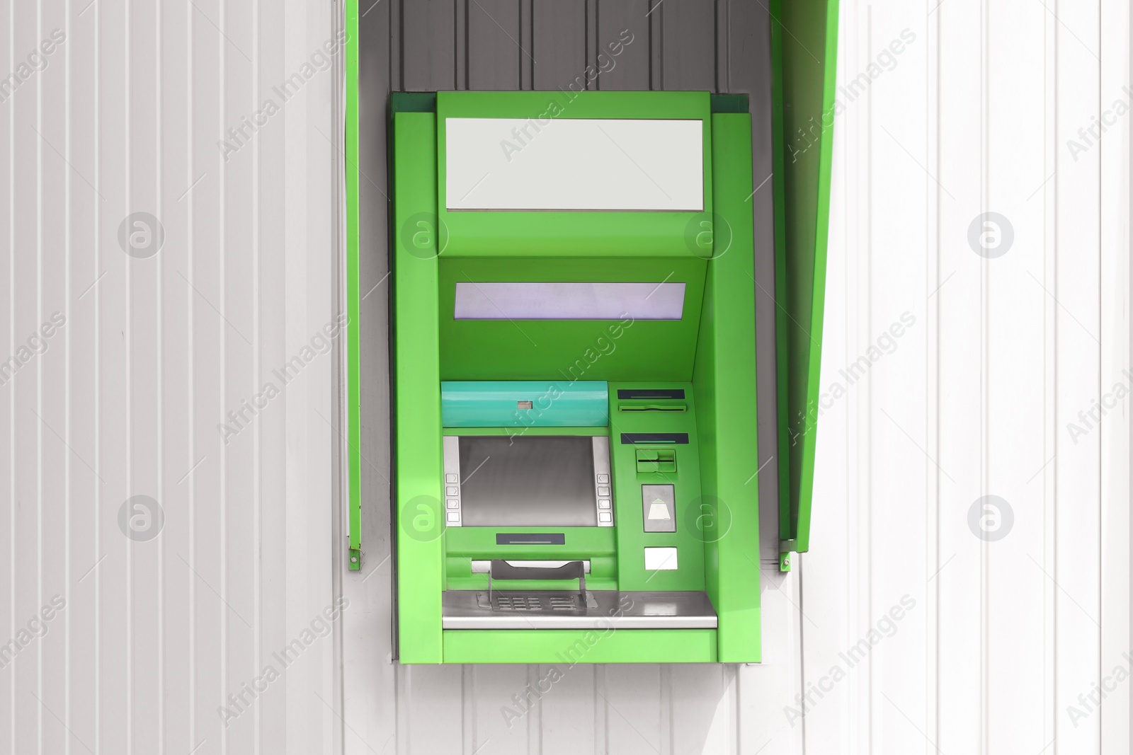 Photo of Modern automated cash machine with screen outdoors