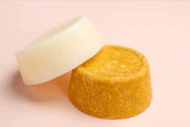 Photo of Solid shampoo bars on pink background, closeup. Hair care