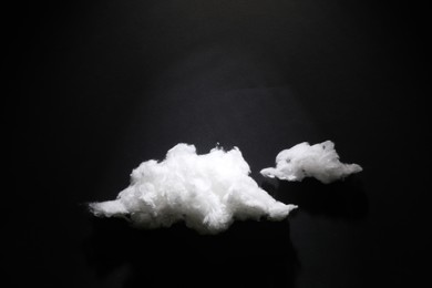 Photo of Clouds made of cotton on black background. Space for text