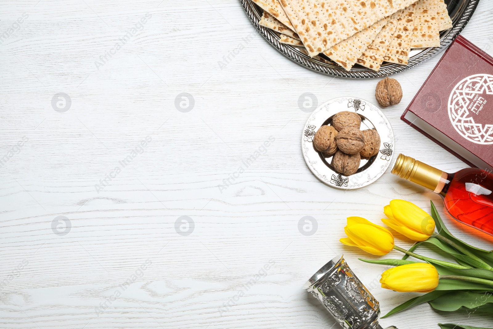 Photo of Flat lay composition with symbolic Passover (Pesach) items on wooden background, space for text