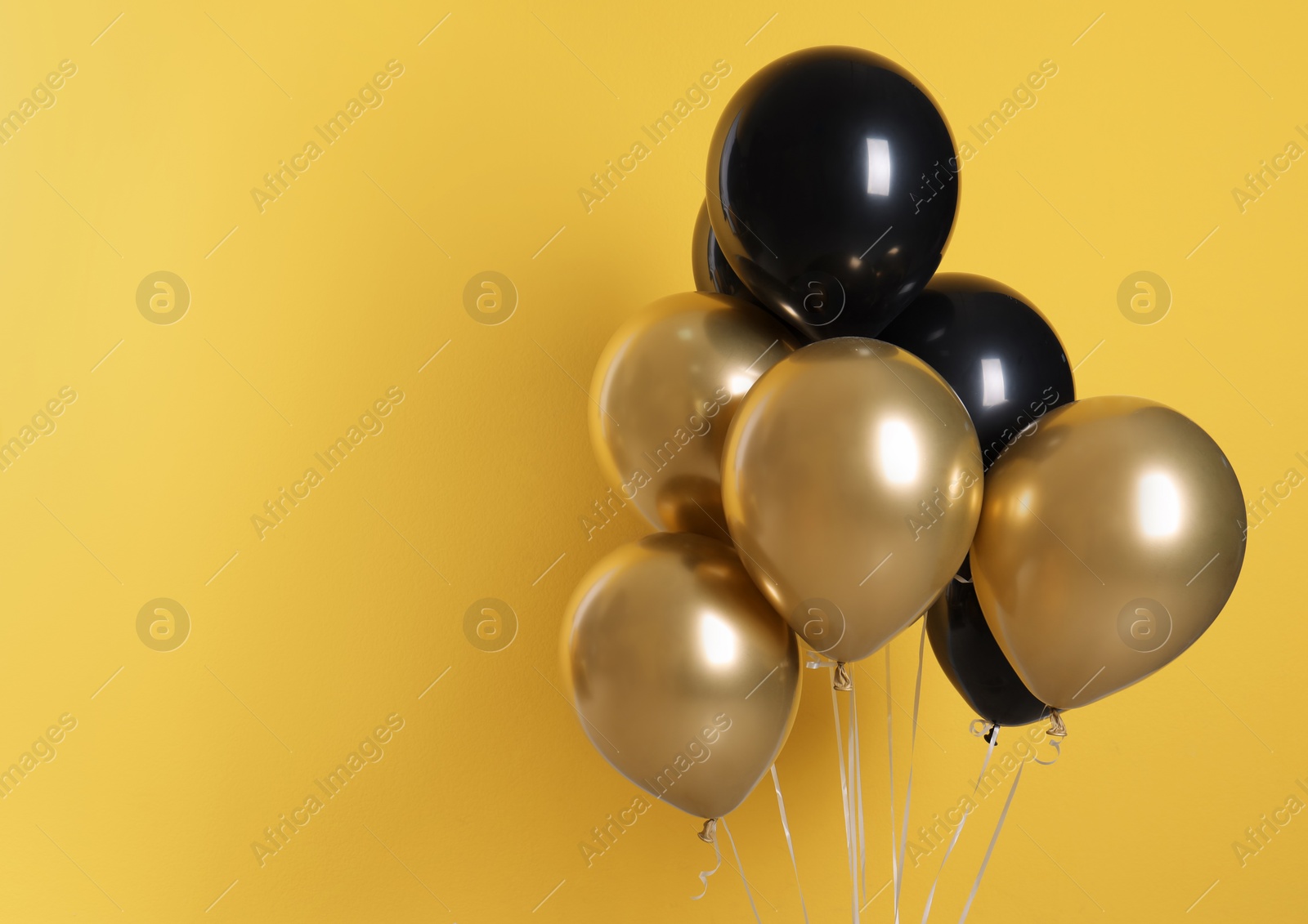 Photo of Different helium party balloons on color background. Space for text