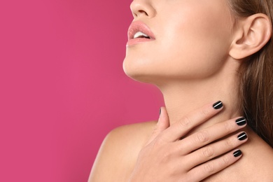 Beautiful woman with stylish nail polish on color background, closeup. Space for text