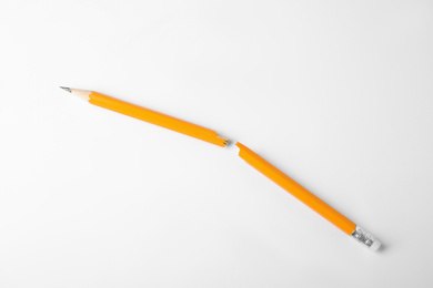 Photo of Broken graphite pencil with eraser on white background
