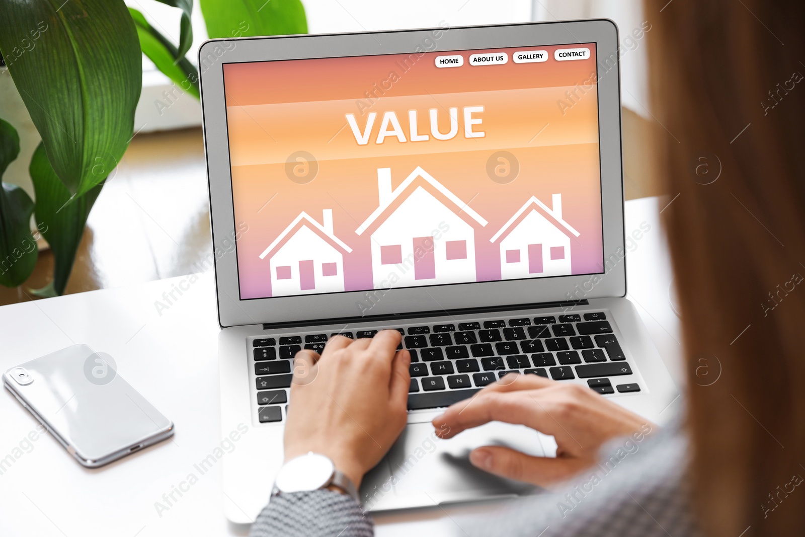 Image of Property value concept. Woman working with laptop at table indoors, closeup