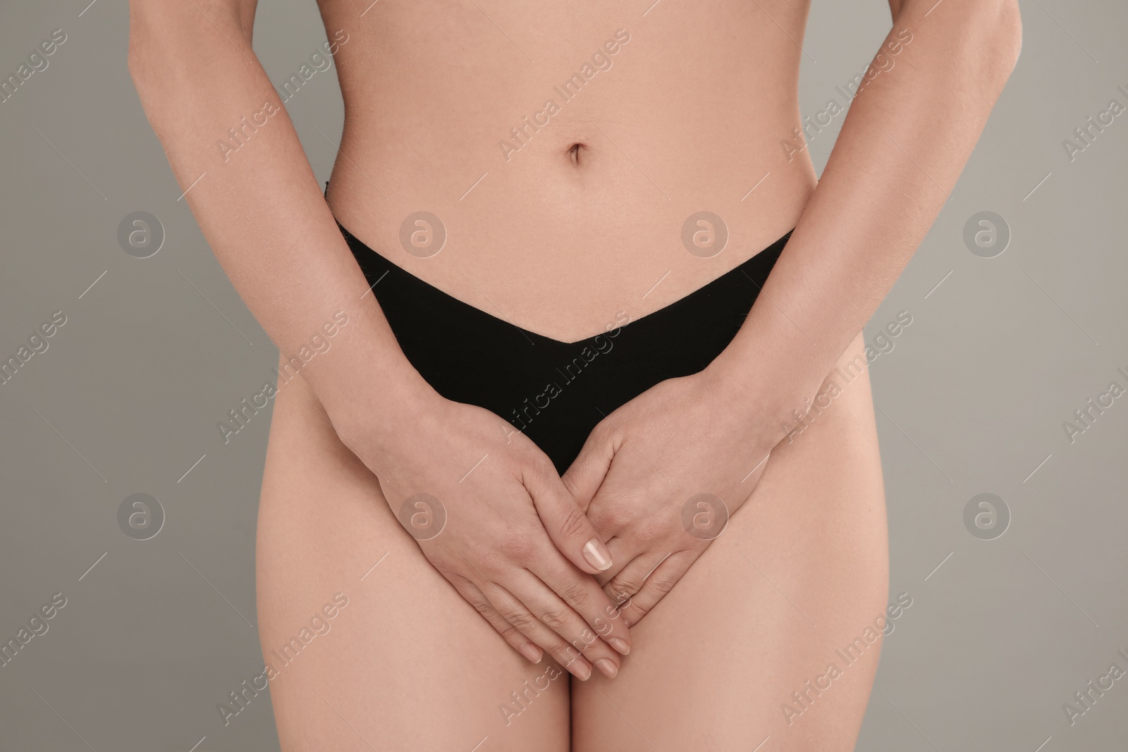 Photo of Gynecology. Woman in underwear on grey background, closeup