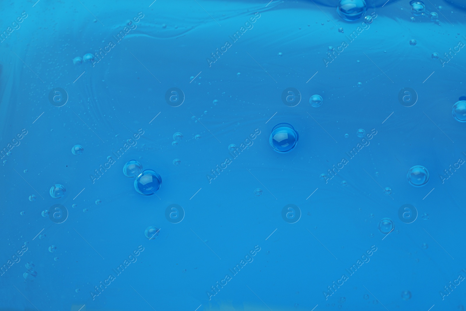 Photo of Sample of blue cosmetic gel as background, closeup