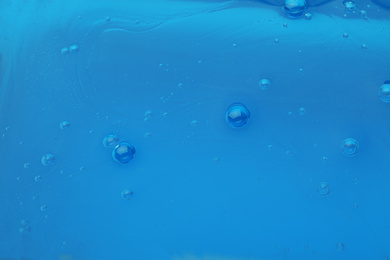 Photo of Sample of blue cosmetic gel as background, closeup