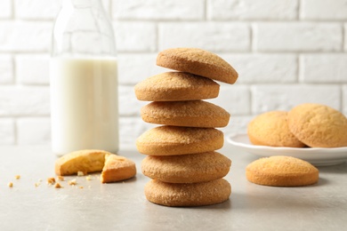 Photo of Stack of Danish butter cookies and milk on table against brick wall