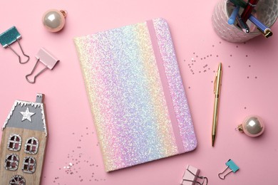 Bright planner, stationery and festive decor on pink background, flat lay. New Year aims