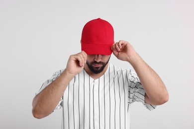 Photo of Man in stylish red baseball cap on white background