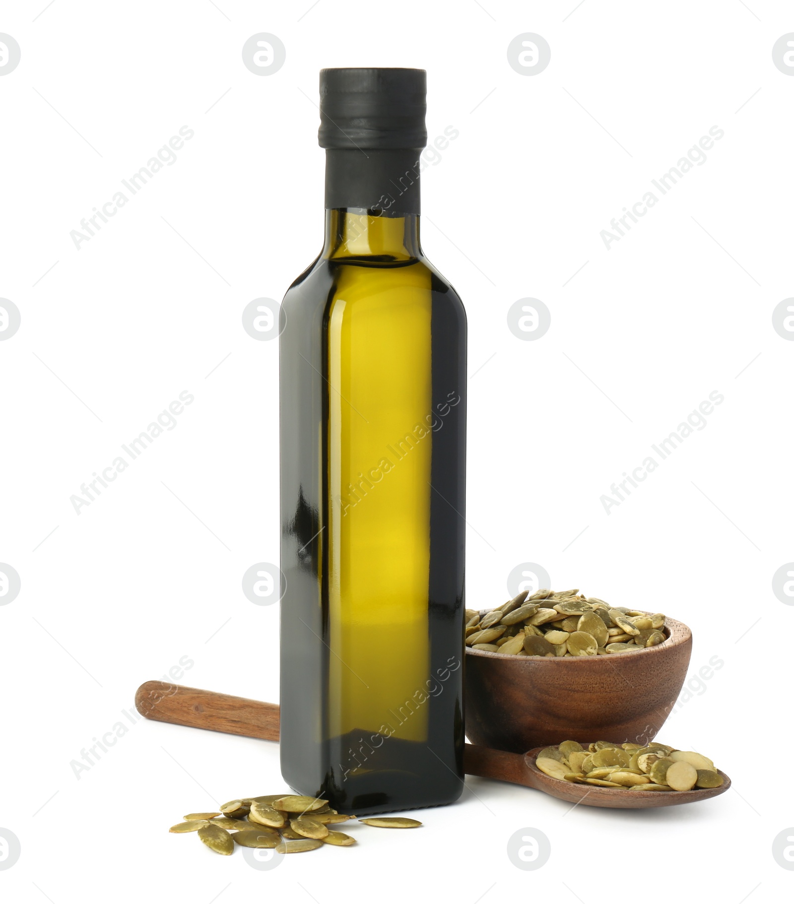 Photo of Vegetable fats. Cooking oil in glass bottle and pumpkin seeds isolated on white