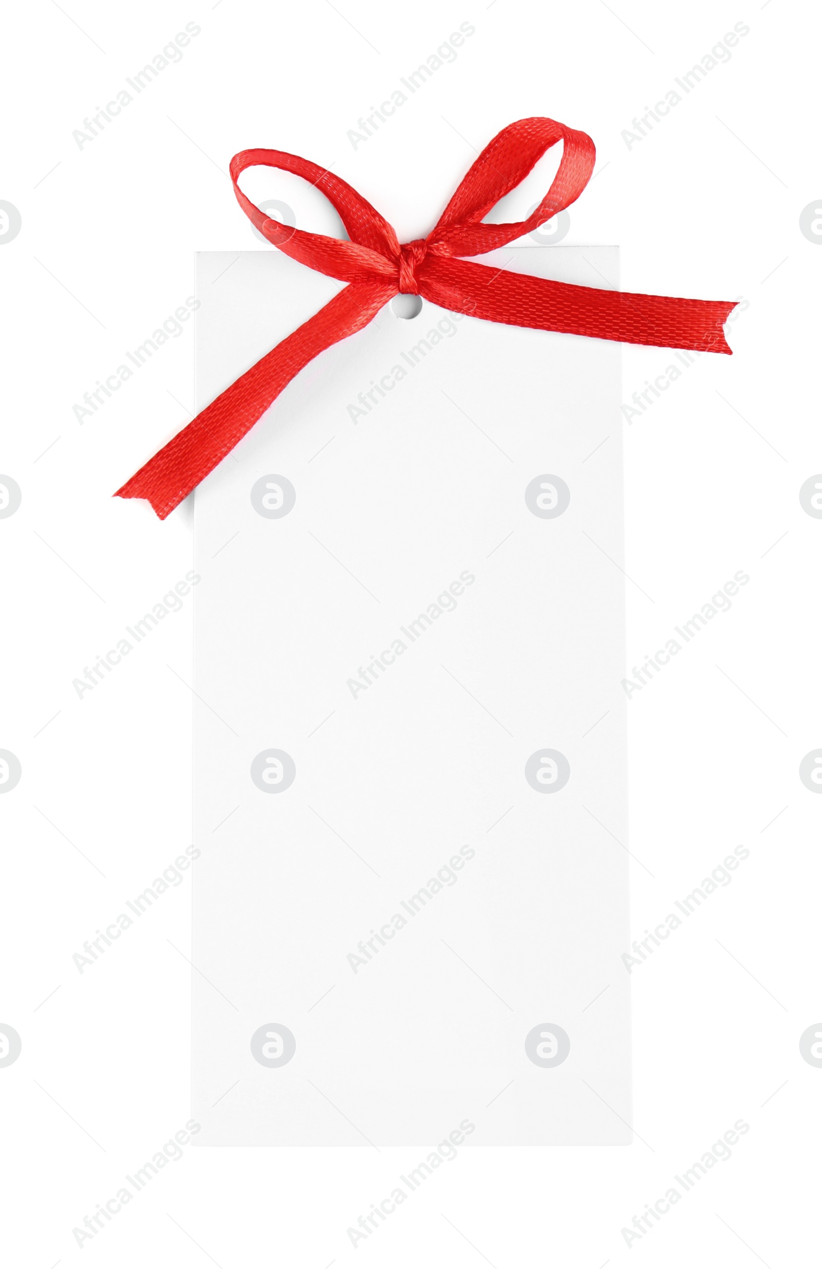 Photo of Blank gift tag with red satin ribbon on white background, top view. Space for design