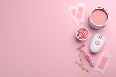 Photo of Set of epilation tools and products on pink background, flat lay. Space for text