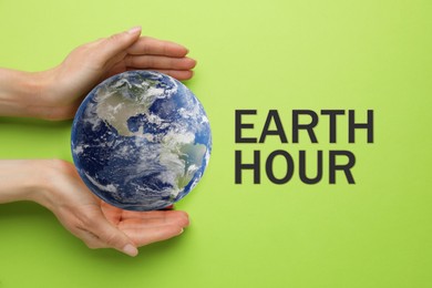 Take care of Earth, turn off lights for hour. Woman with globe illustration on light green background, top view