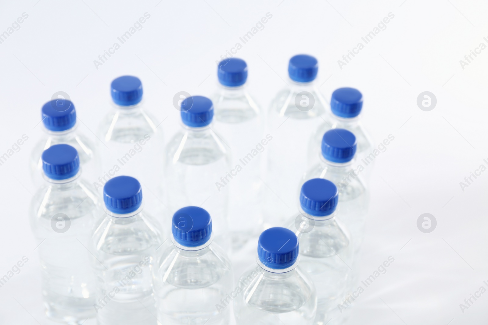 Photo of Heart made with plastic bottles of pure water on white background