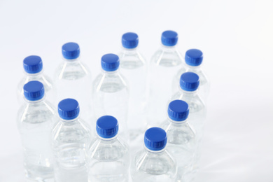 Photo of Heart made with plastic bottles of pure water on white background