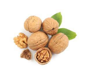 Photo of Pile of ripe walnuts and leaves on white background, top view
