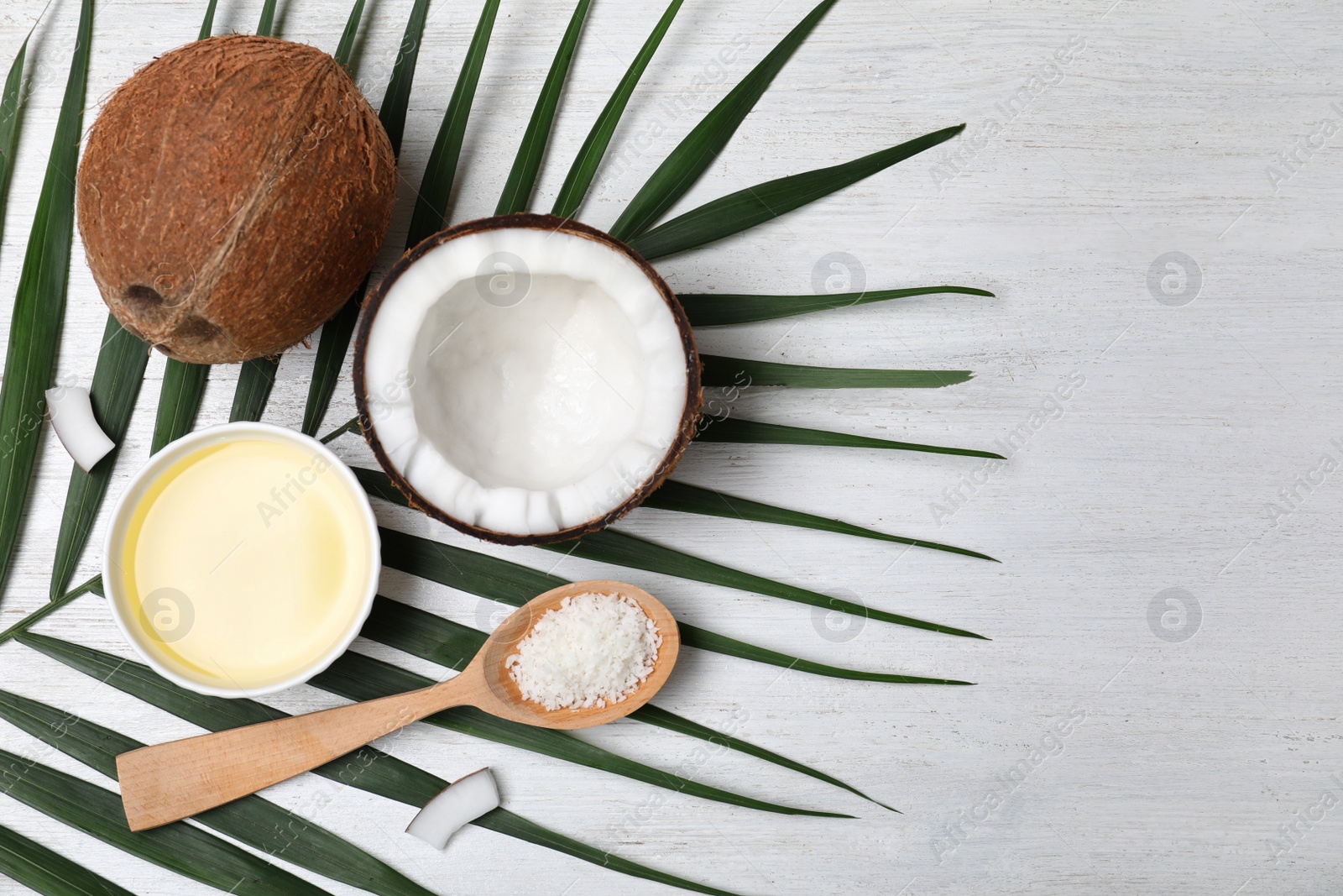 Photo of Flat lay composition with natural organic coconut oil on wooden background. Space for text