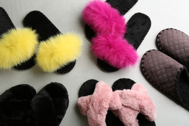 Photo of Many different soft slippers on light grey background, flat lay