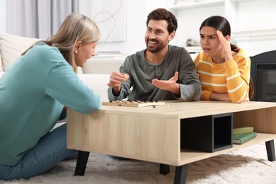Family talking while playing checkers at home