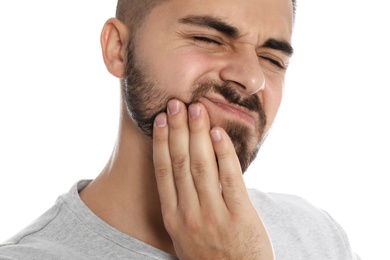 Photo of Man suffering from acute toothache on white background, closeup