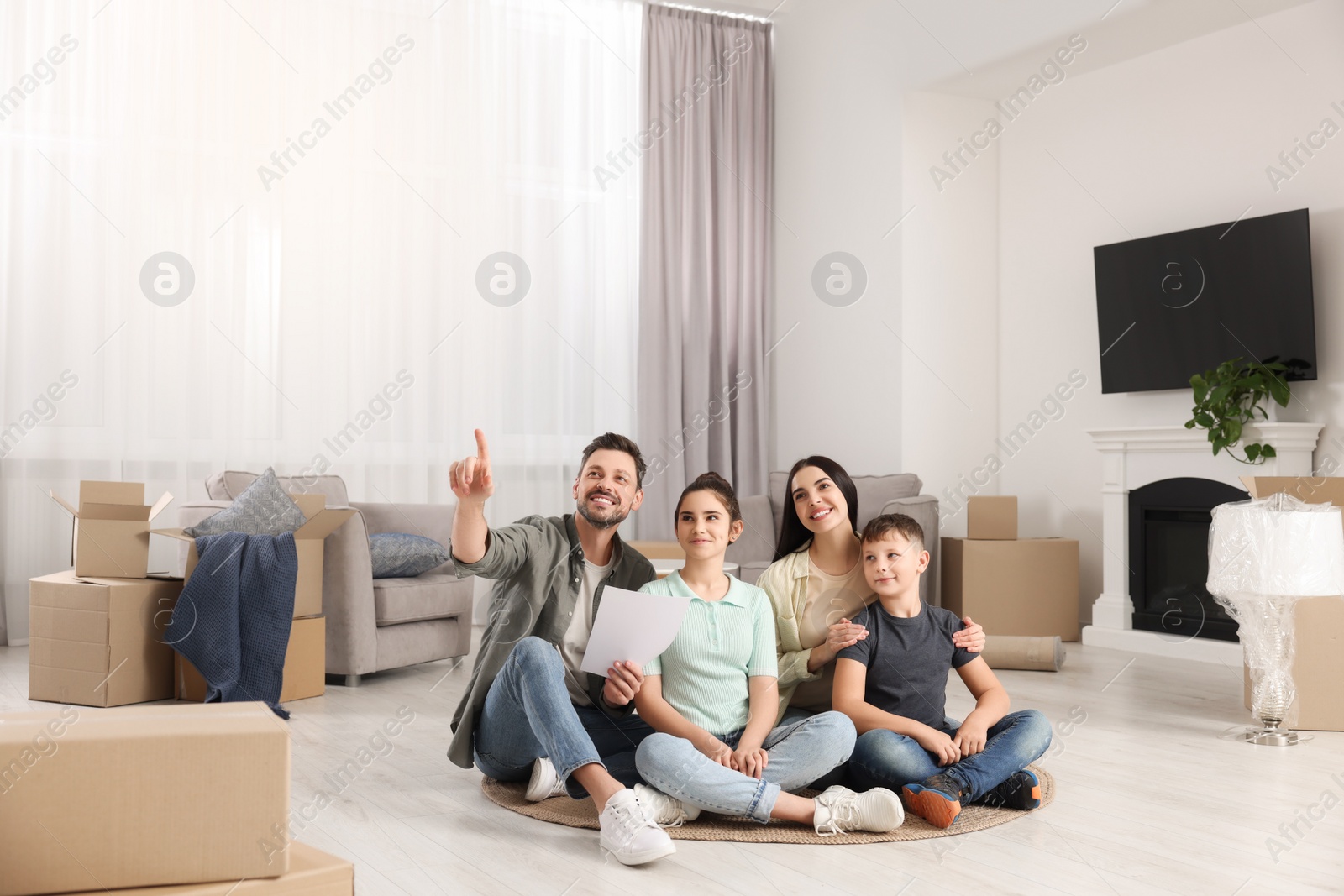 Photo of Happy family spending time in new apartment. Moving day