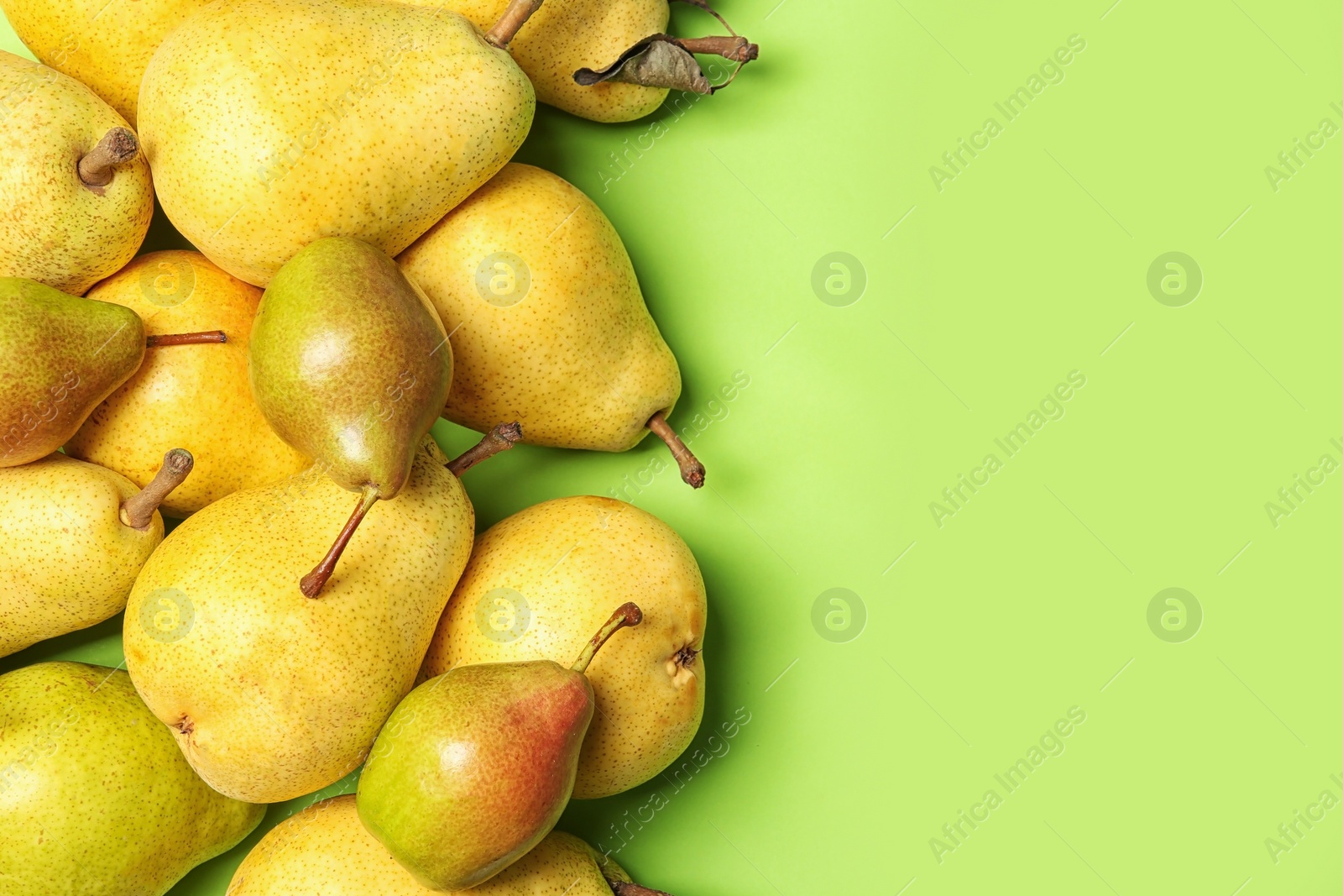 Photo of Flat lay composition with fresh ripe pears and space for text on color background