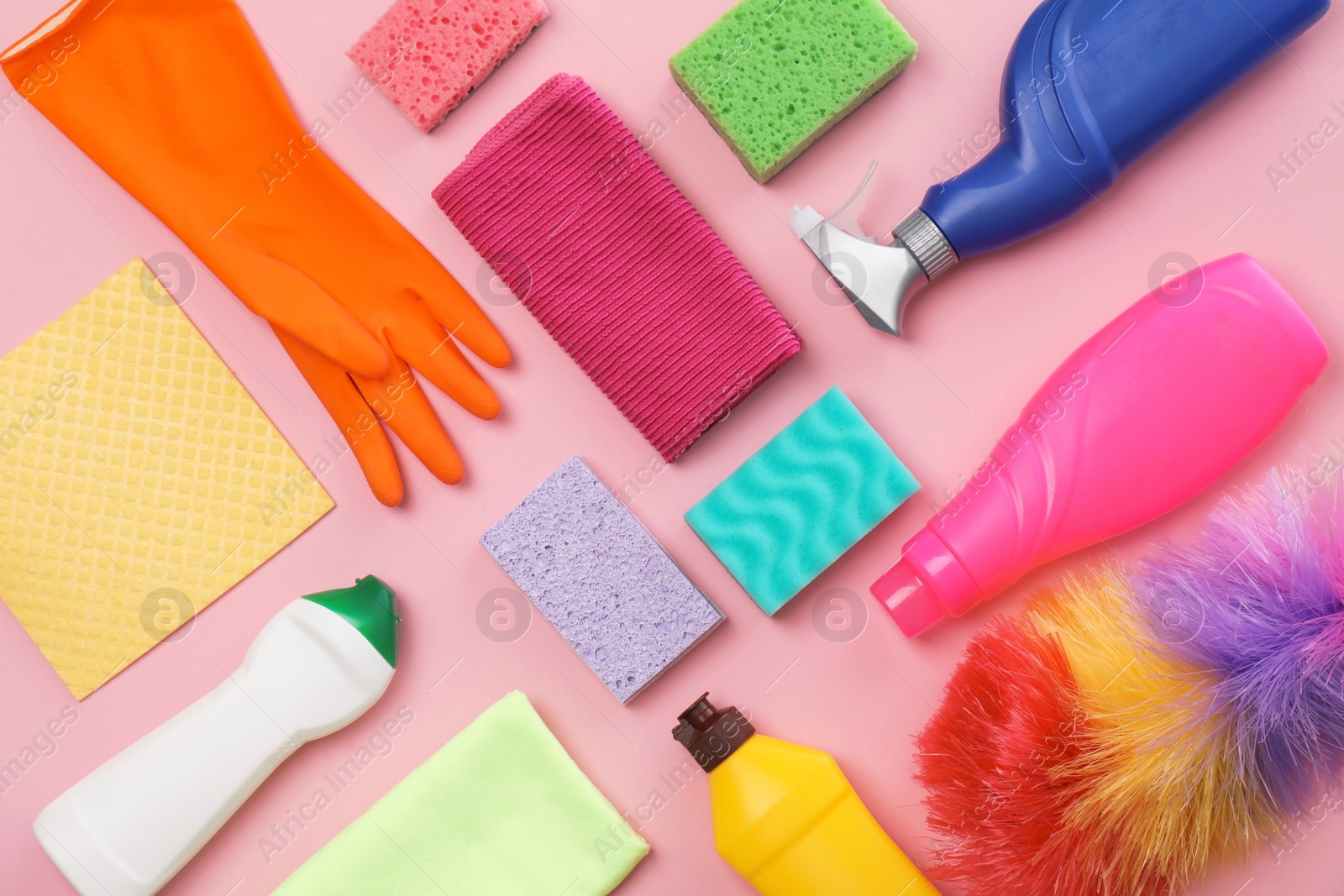 Photo of Flat lay composition with cleaning supplies on color background