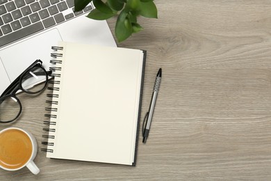 Photo of Flat lay composition with notebook and laptop on wooden table, space for text