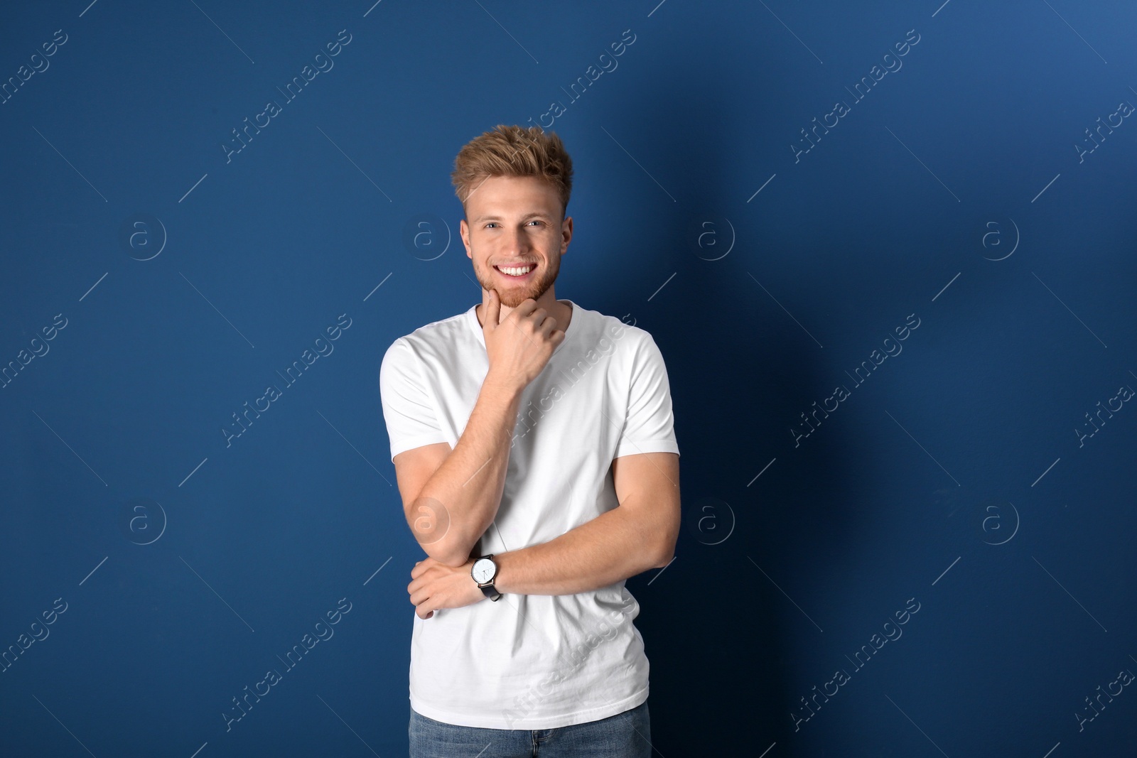 Photo of Portrait of handsome young man on blue background