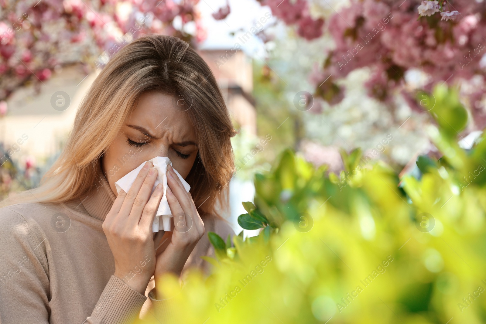 Photo of Woman suffering from seasonal pollen allergy outdoors