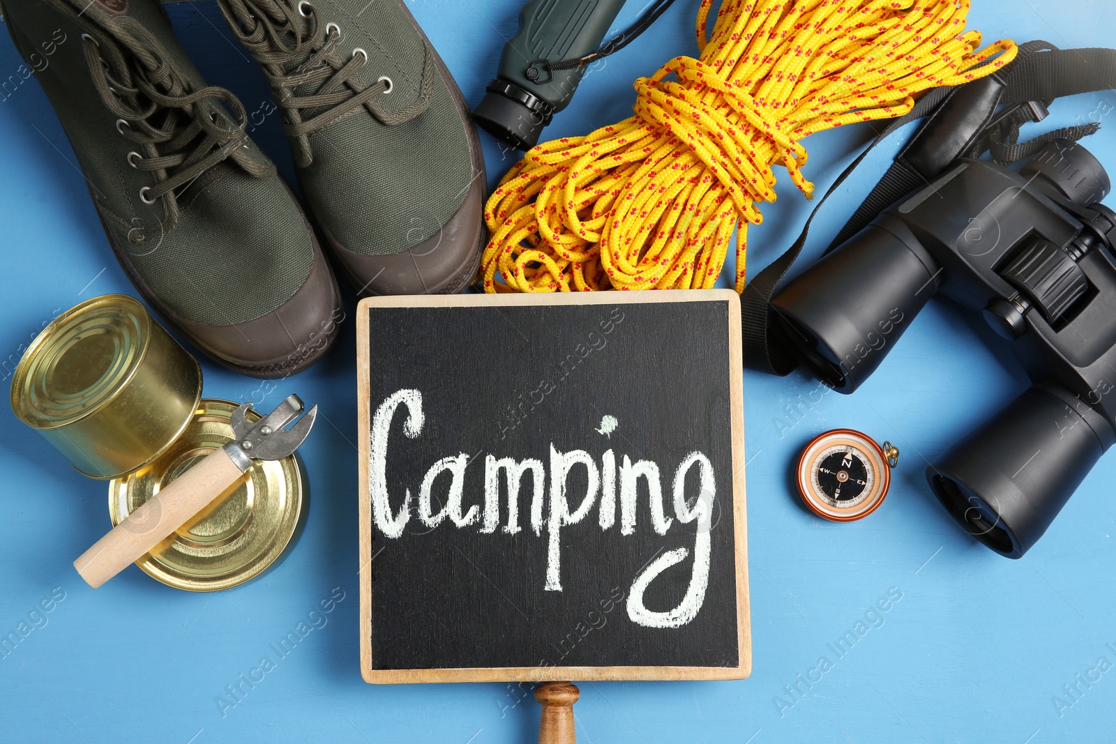 Photo of Flat lay composition with camping equipment on color background