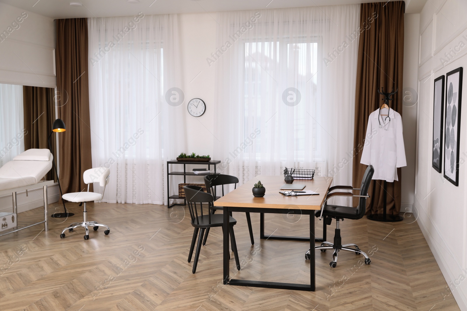 Photo of Modern medical office interior with doctor's workplace and chairs