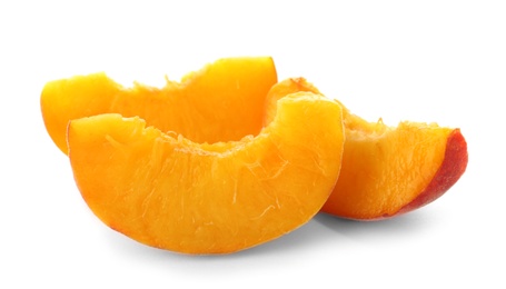 Slices of fresh sweet peach on white background