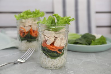 Photo of Healthy salad in glass jars on marble table