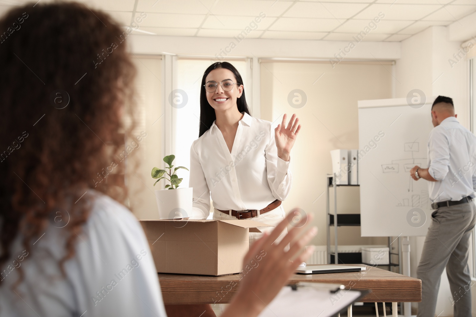 Photo of Employee greeting new coworker in modern office