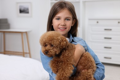 Photo of Little child with cute puppy at home. Lovely pet