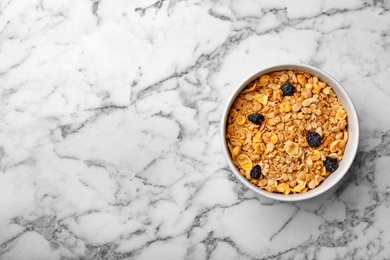 Photo of Bowl of whole grain cereal on marble table, top view with space for text