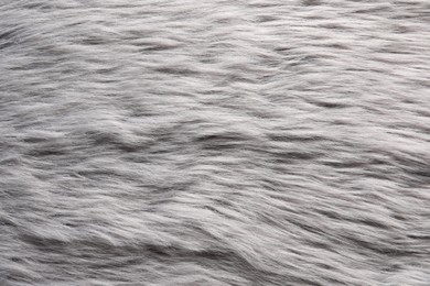 Photo of Texture of grey faux fur as background, top view