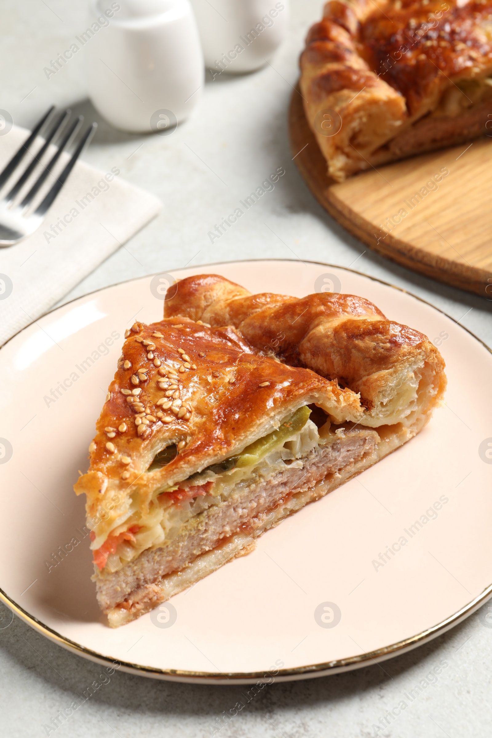 Photo of Piece of tasty homemade pie with filling on light grey table